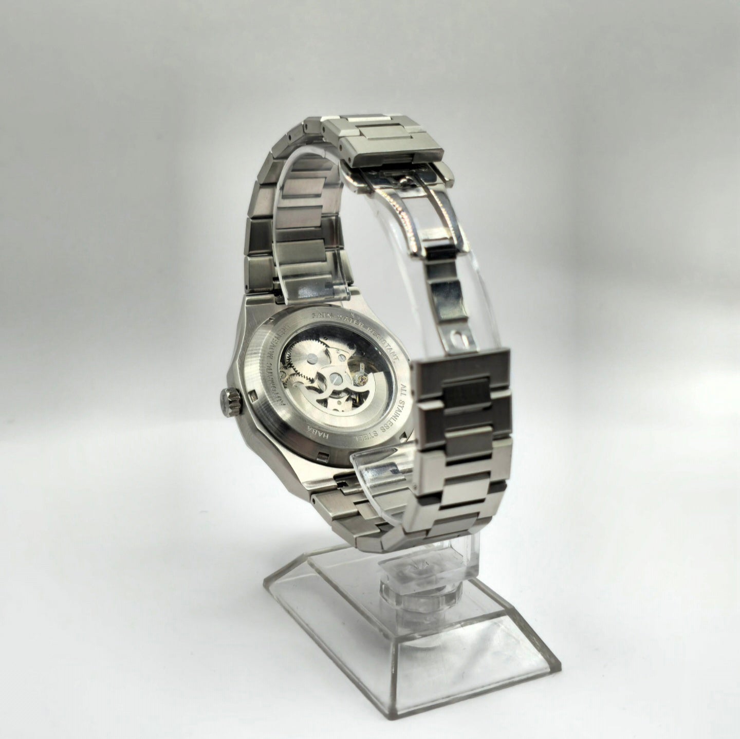 Montre automatique Arabic Dial pour homme avec chiffre arabe et cadran bleu vu de de dos et posé sur un support.